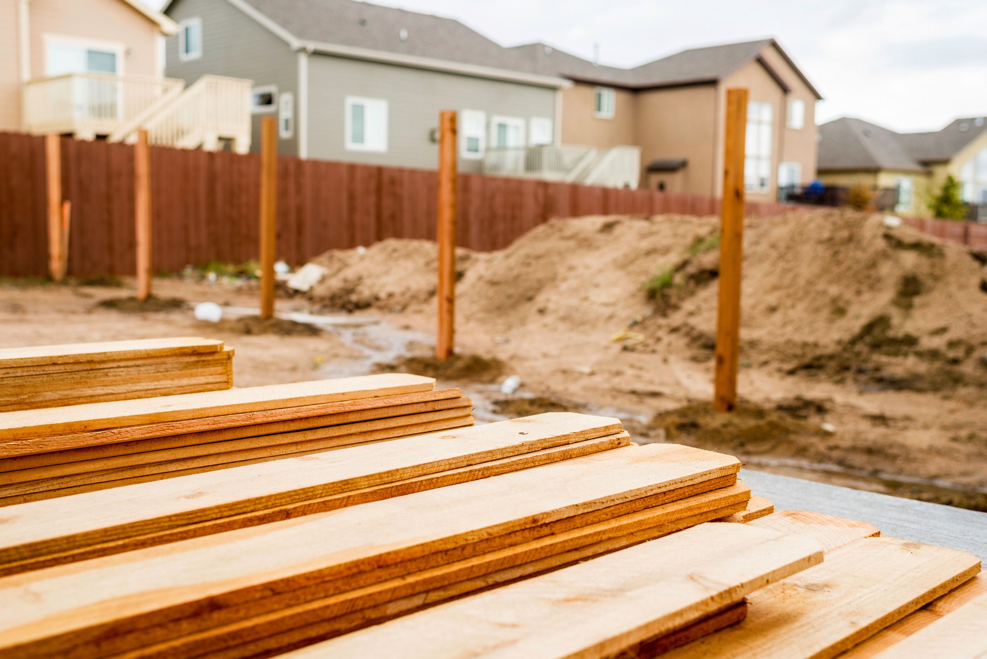 New fence construction. Fence posts in background, timber in foreground.